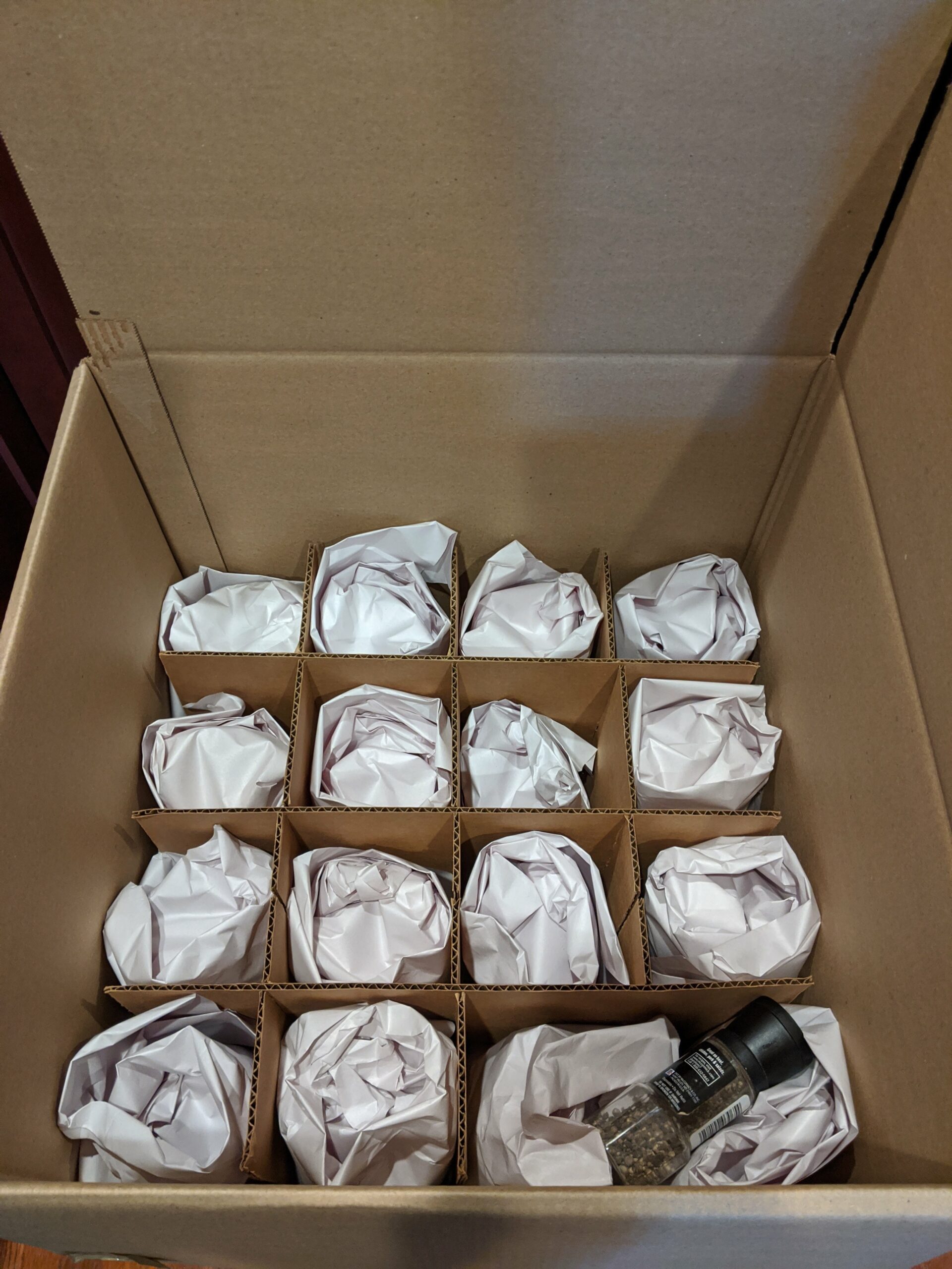 Carefully packed box with cardboard insert, designed to protect fragile glass items