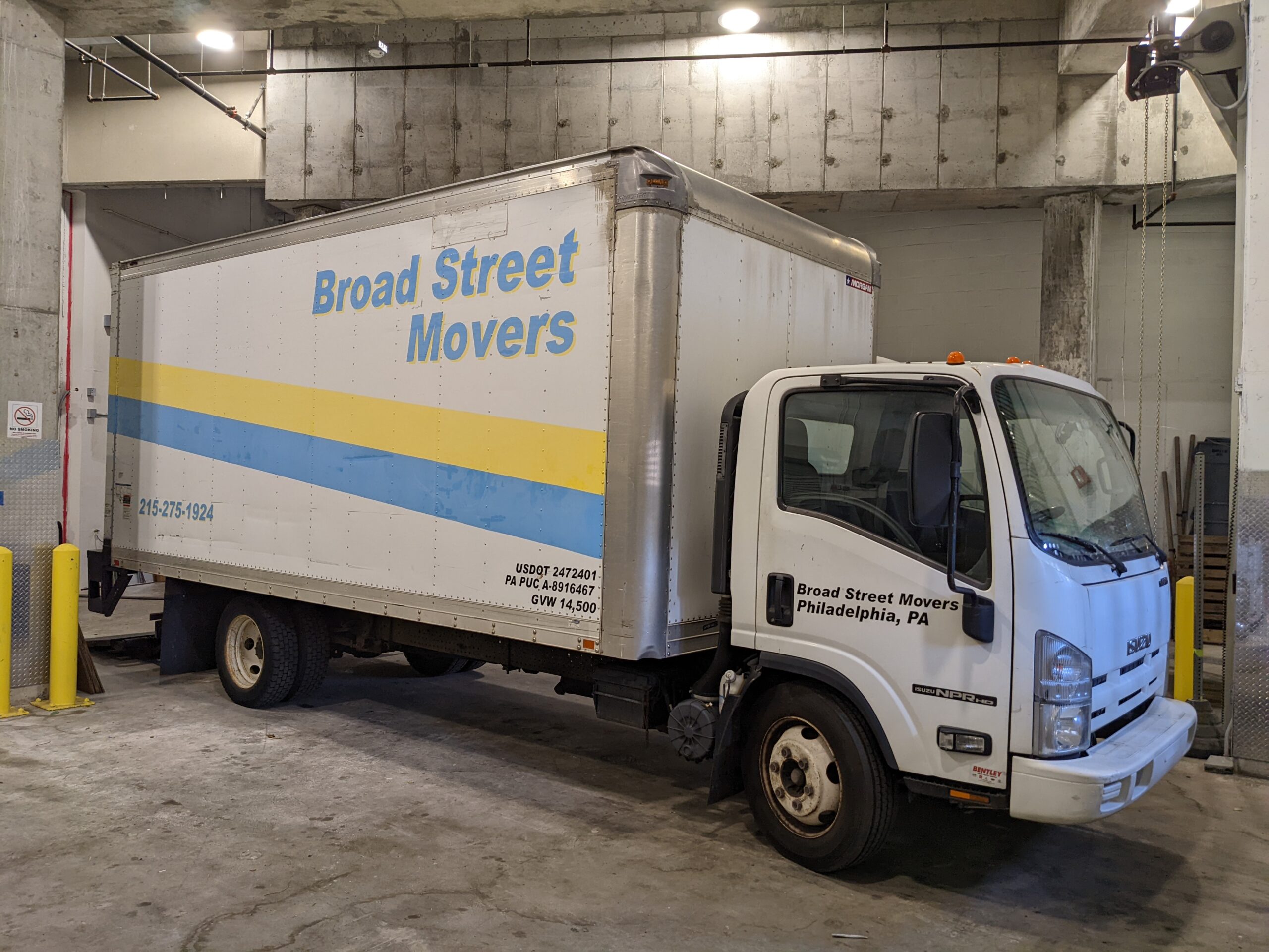 Broad Street Movers moving truck parked inside warehouse located in the Philly area