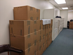 Several stacks of neatly packed boxes in a office during a corporate relocation move