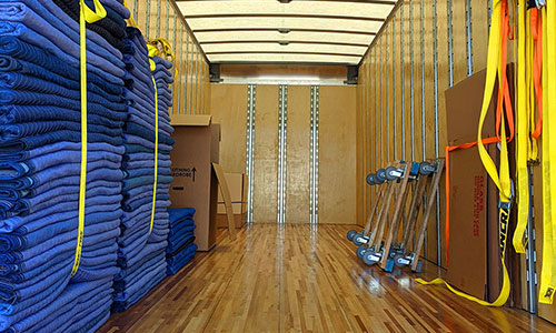 The back of a moving truck, all clean and clear before a long-distance move begins.