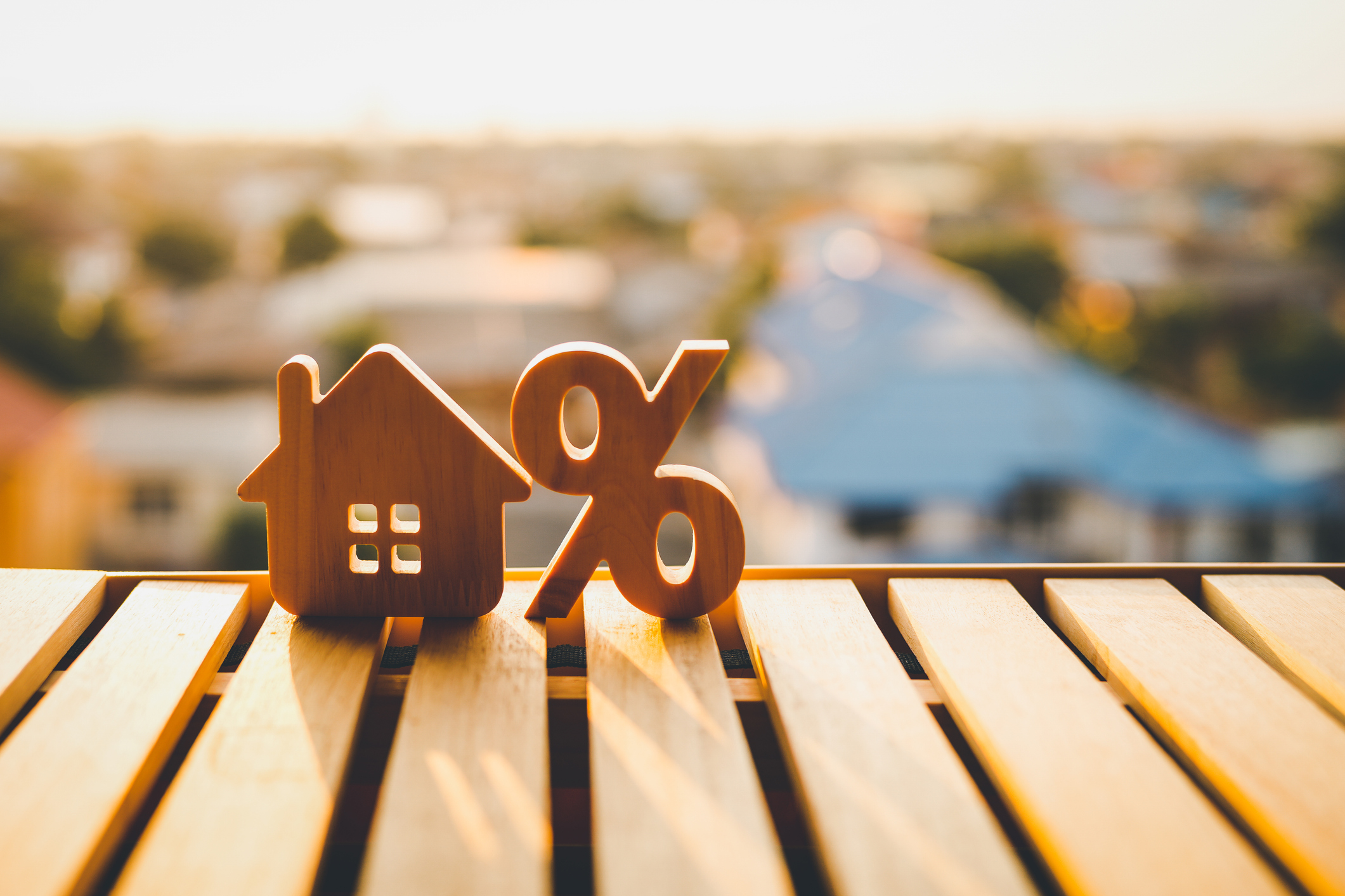 Percentage And House Sign Symbol Icon Wooden On Wood Table. Concepts of Rising Mortgage rates.