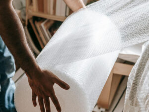 A homeowner in Philly is packing his furniture with bubble wrap to keep it protected for his upcoming move.